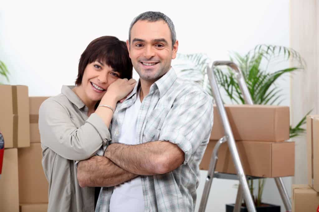 A couple ready to move out with boxes surrounding them