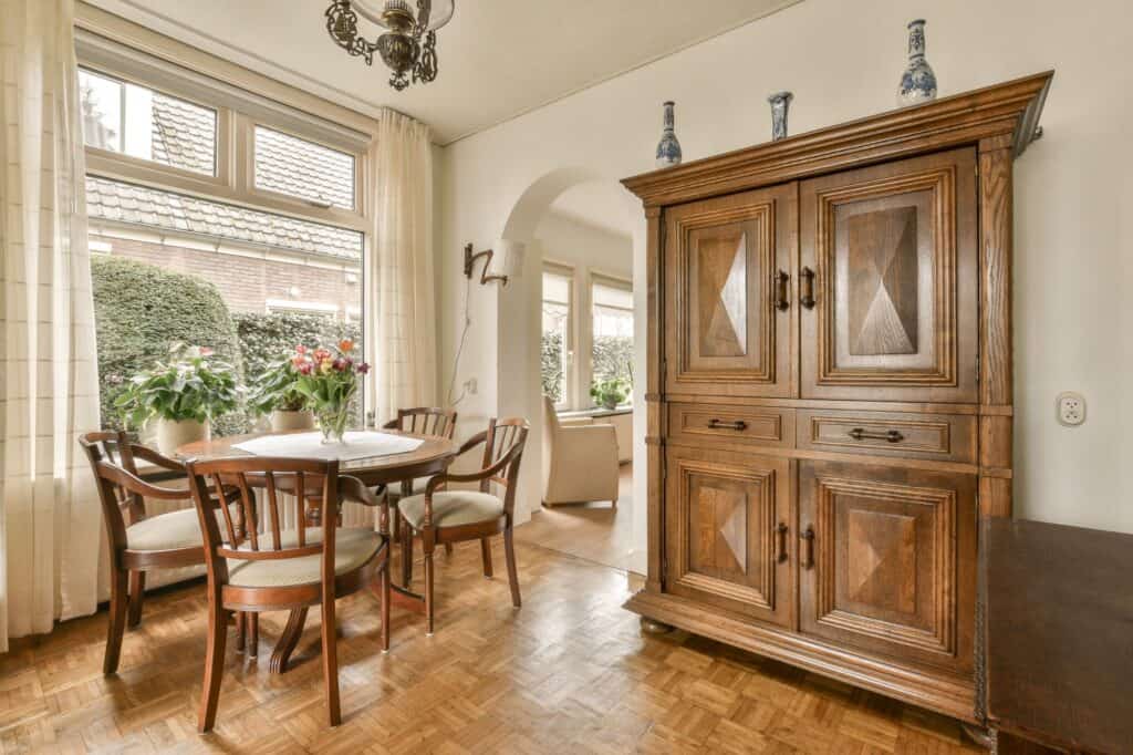 A dining area with a large wooden cabinet