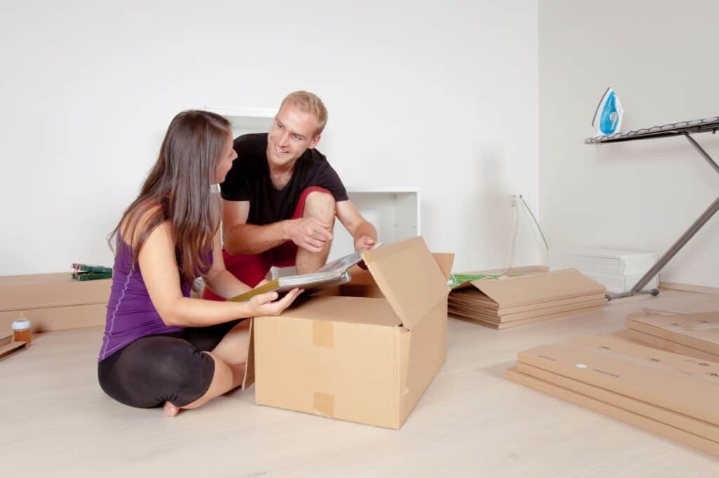 A young couple starting to pack things for moving