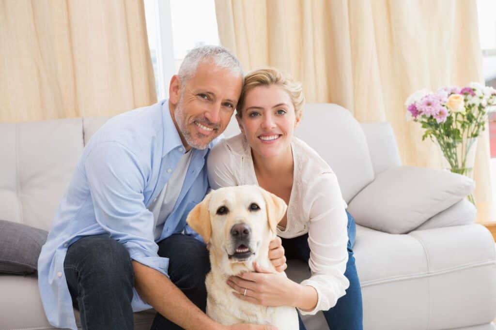 A happy couple with their pet dog