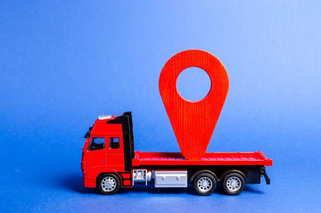 A red toy truck carrying a red location pointer