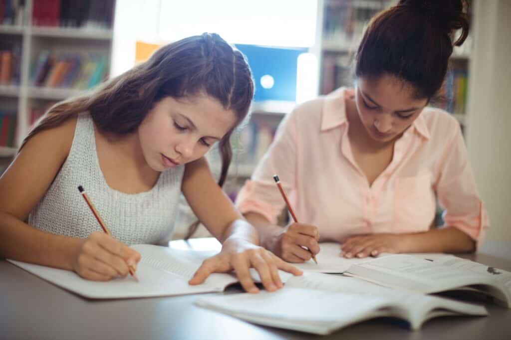 Female students studying in a library in the concept of 'top schools in Croydon'.