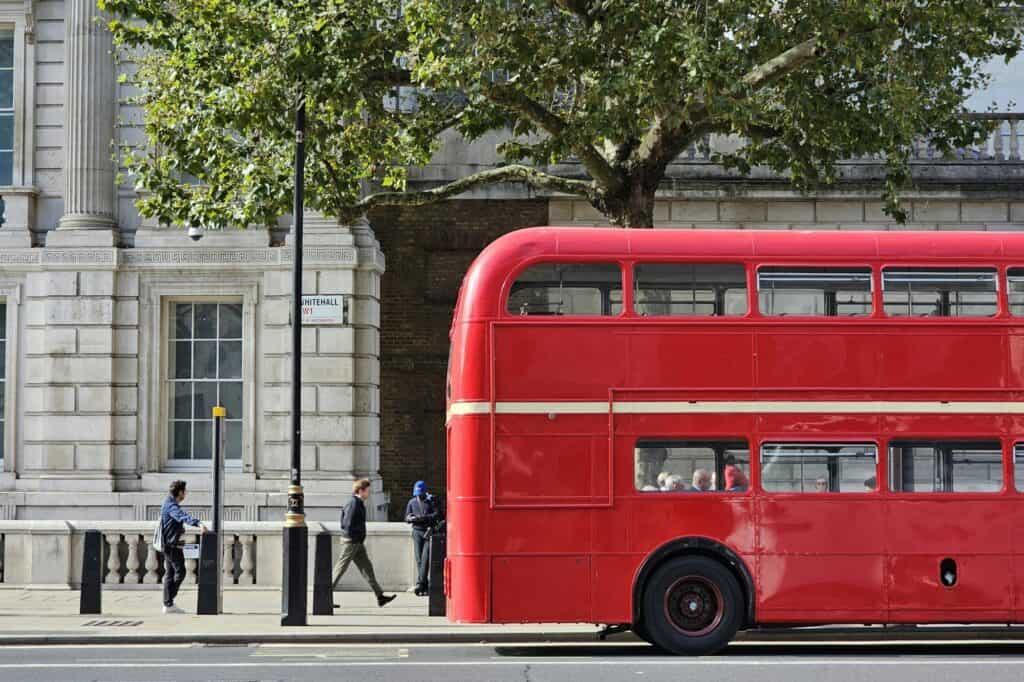 A double-decker bus picking up passengers