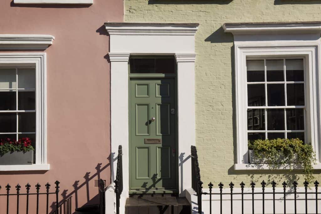 Front view of a townhouse with green door in the concept of 'best affordable housing options when moving to Croydon.