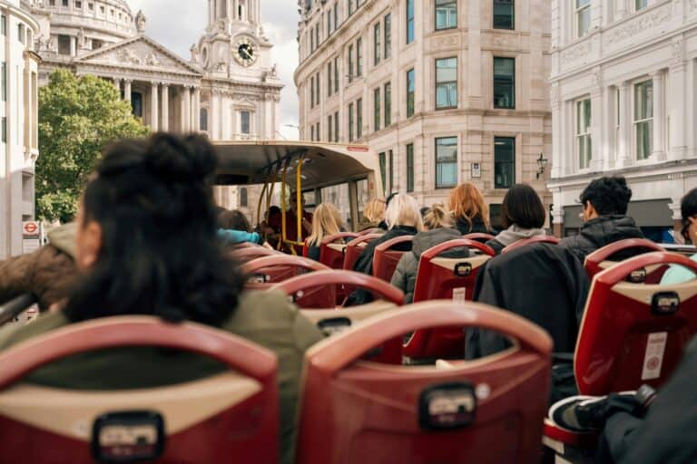 Passengers sitting at the top-most portion of the iconic London bus in the concept of 'how to use Croydon's public transport'.