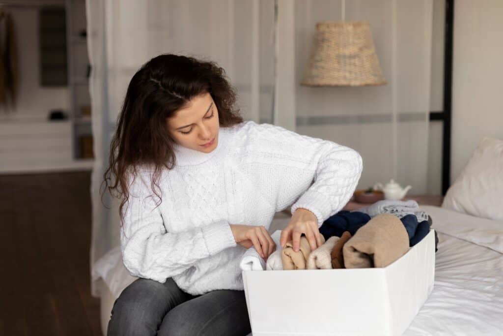 A young woman settling in the bedroom after moving in